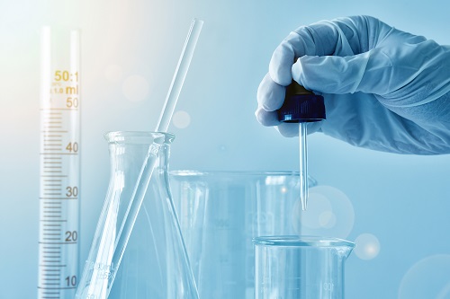 A close-up of a laboratory glass, Dropping substances in to solu